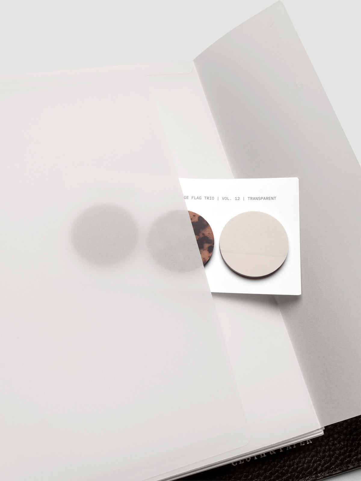 White Envelope Storage Holder shown inside a black, leather A5 agenda with page flags inside.