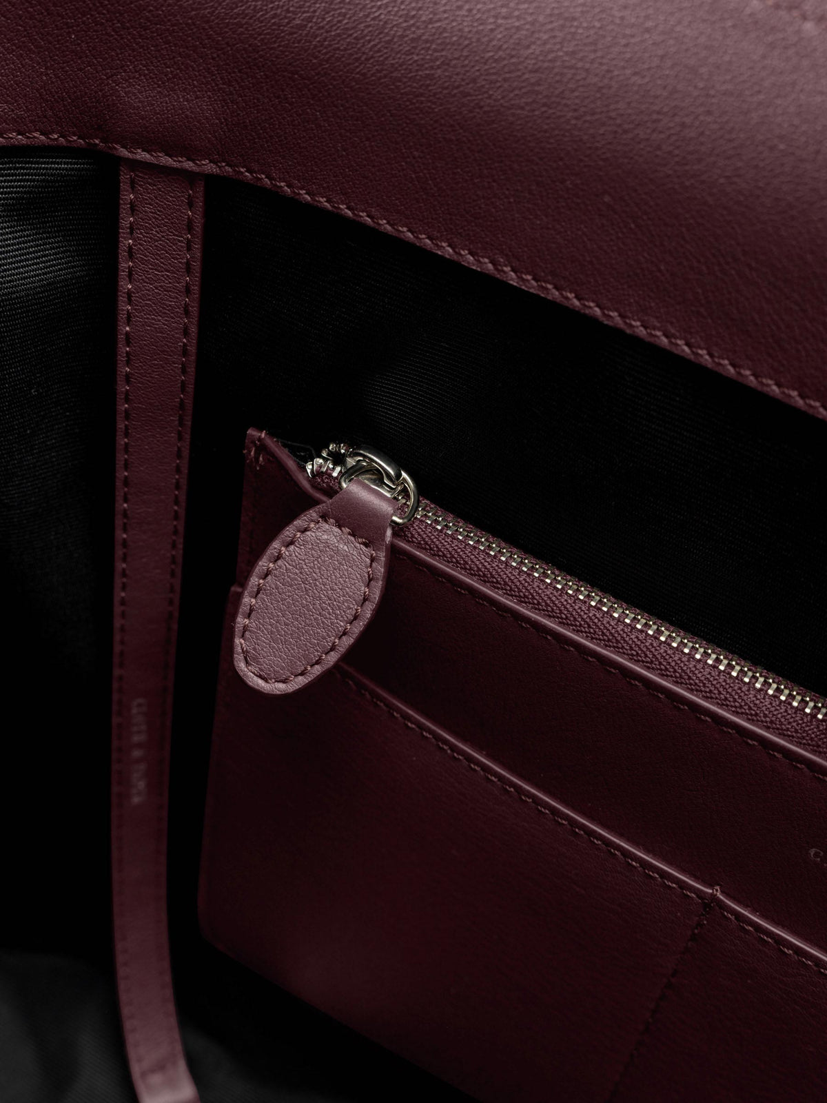 Detail view of the zip closure inner pocket on The Metro Tote in the color Madrid.