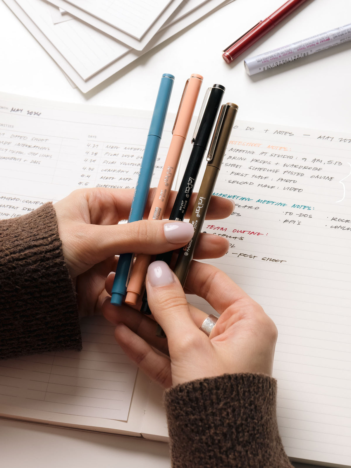 Woman holding multiple Le Pens by Marvy Uchida