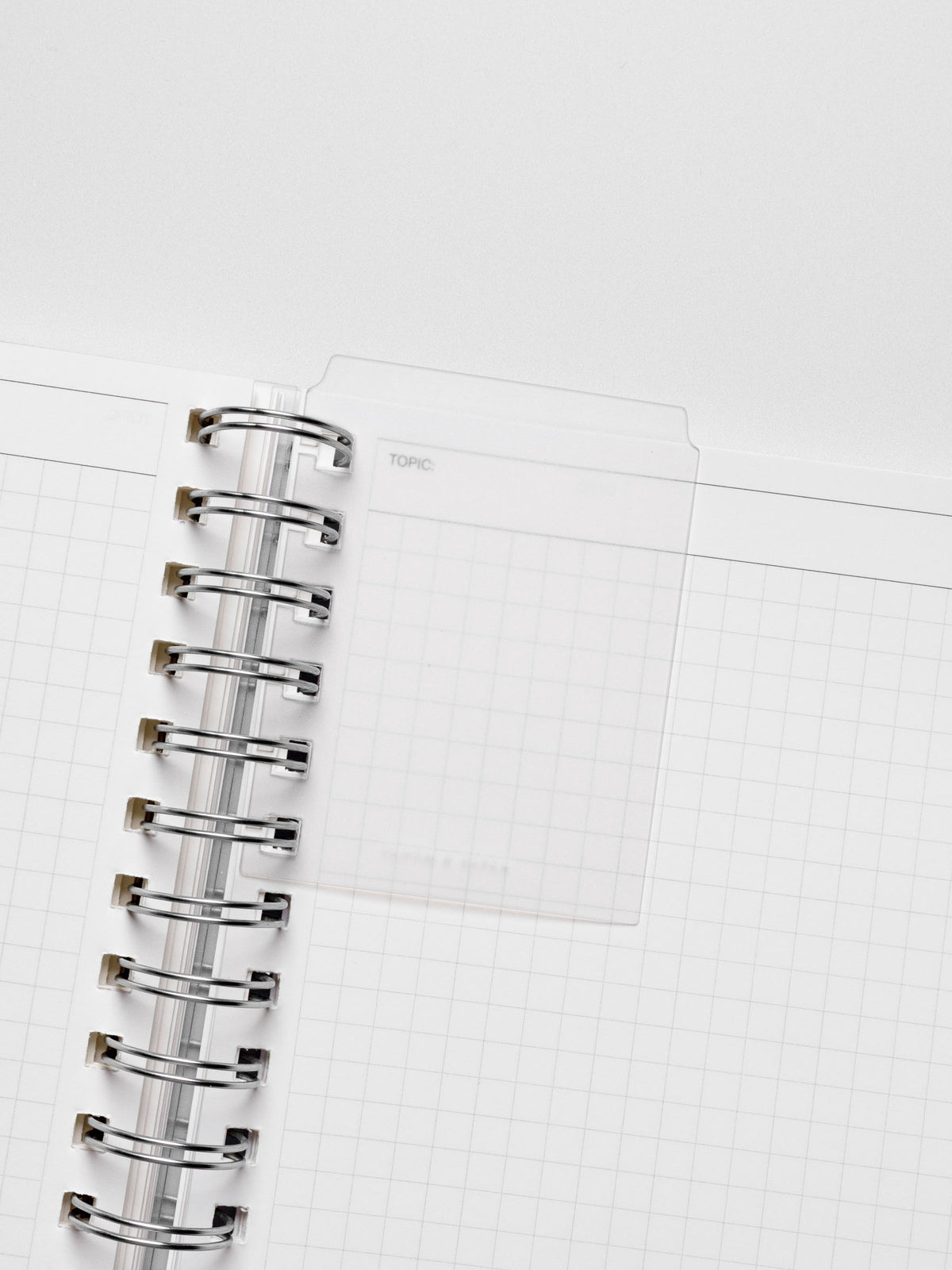Page marker in use with a spiral notebook.