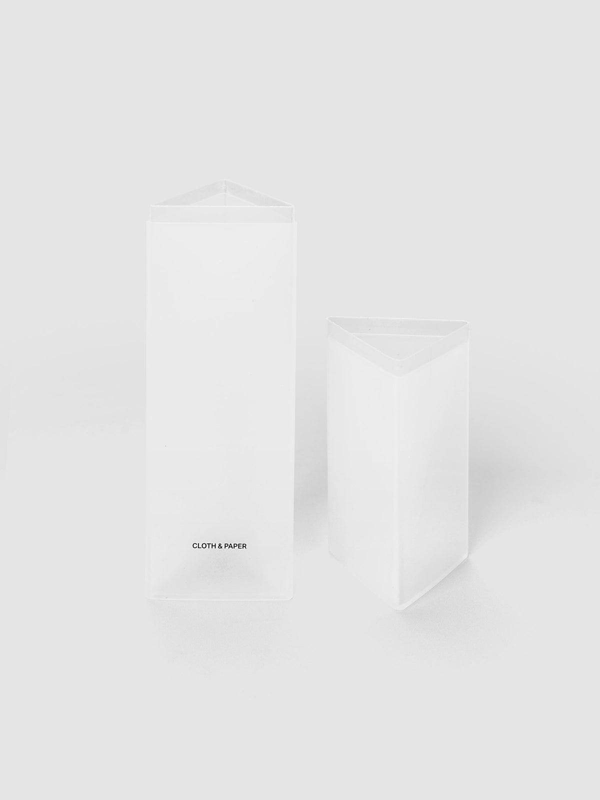 Pencil Box | Frosted, a triangular frosted plastic pencil case with a black logo on a light gray background