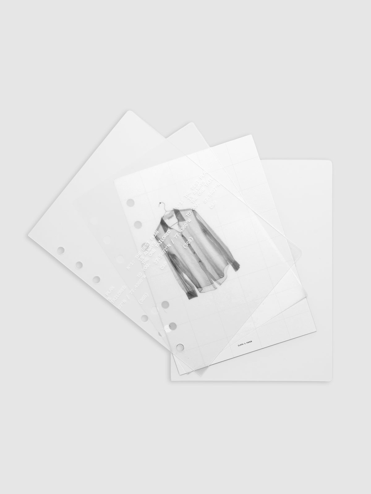 Transparent planner cover set with white printed text design and accompanying black and white dashboard with an image of a tailored shirt on a hanger shown offset. Pre-punched for 6-ring planners shown in size Personal Wide.