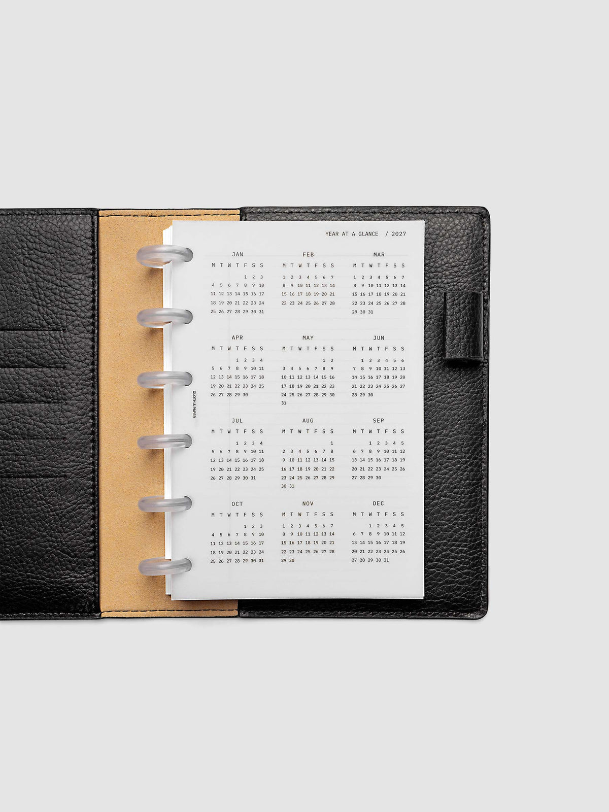 2027 Year At A Glance Dashboard Monday Start, CP Petite 6-Disc Punch, translucent vellum year-at-a-glance calendar shown inside a planner