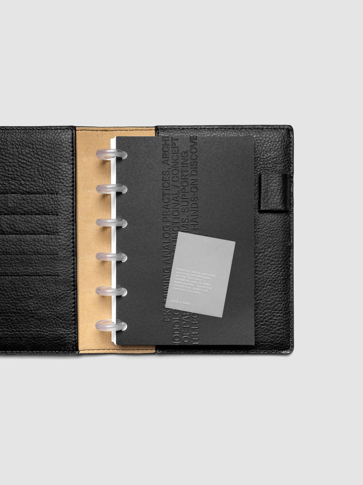 Black embossed Analog Embossed Planner Dashboard with drop card shown in size CP Petite.