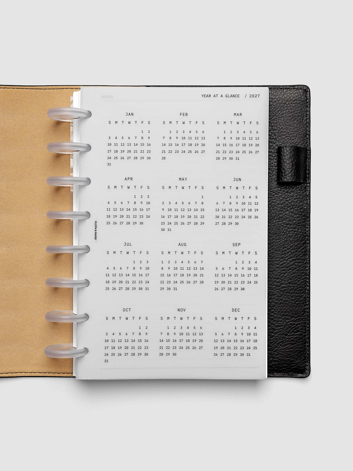 2027 Year At A Glance Dashboard Sunday Start, Half Letter 8-Disc Punch, translucent vellum year-at-a-glance calendar shown inside a planner