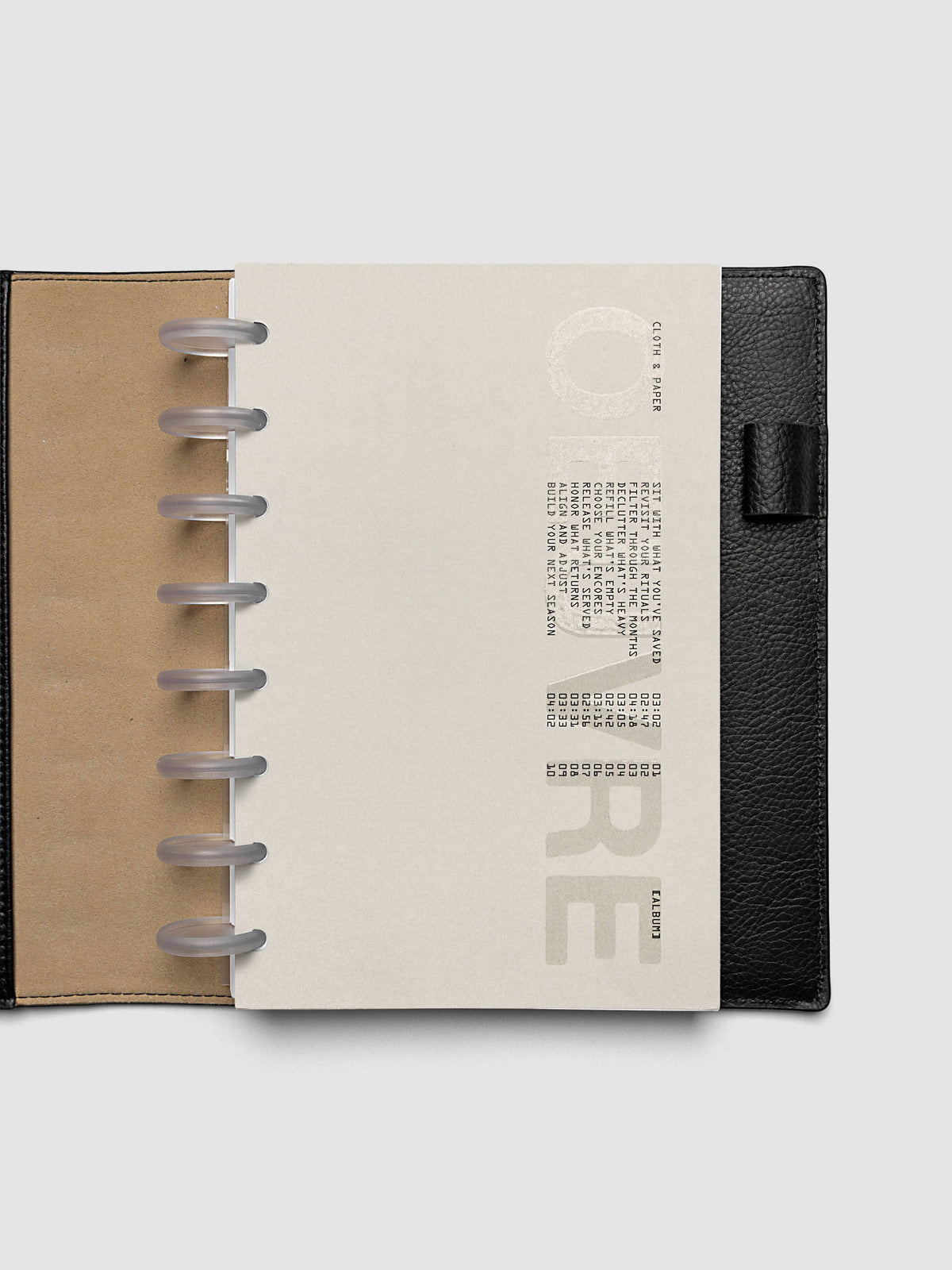 Oeuvre Planner Dashboard in Half Letter 8-Disc Punch size shown in a planner