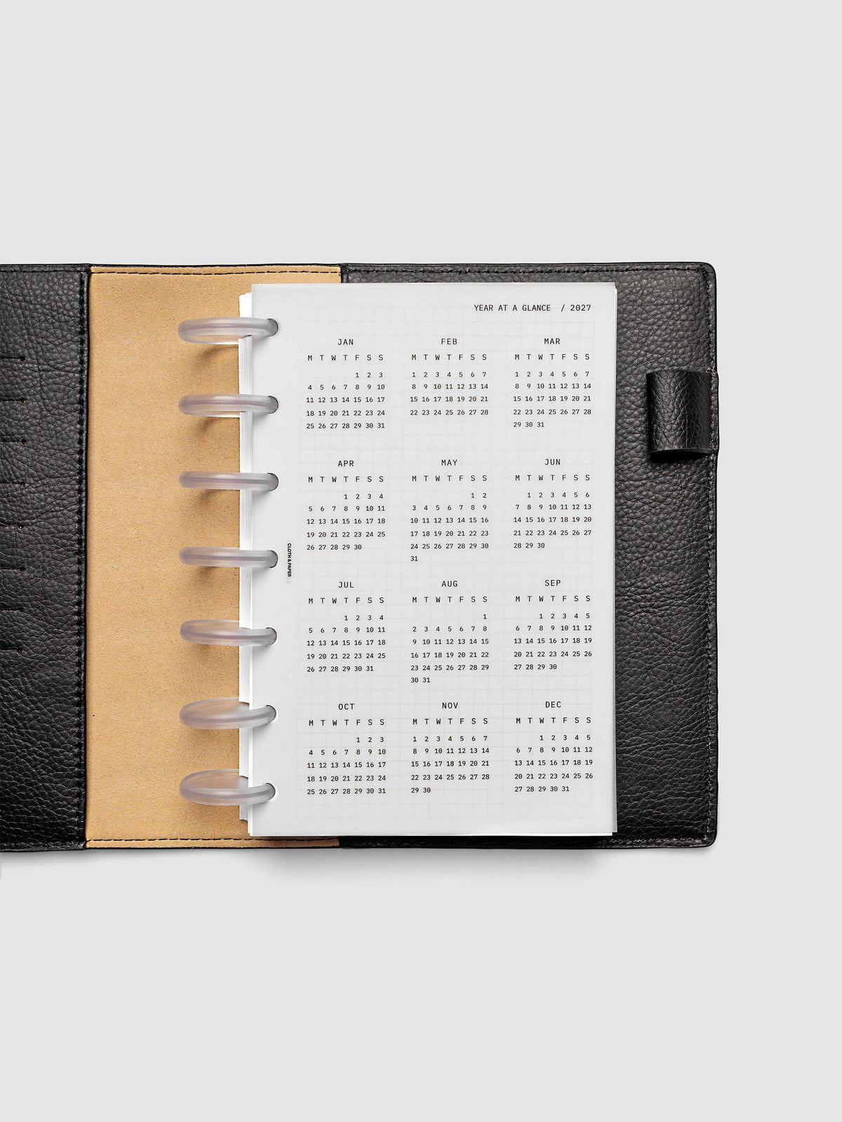 2027 Year At A Glance Dashboard Monday Start, HP Mini 7-Disc Punch, translucent vellum year-at-a-glance calendar shown inside a planner