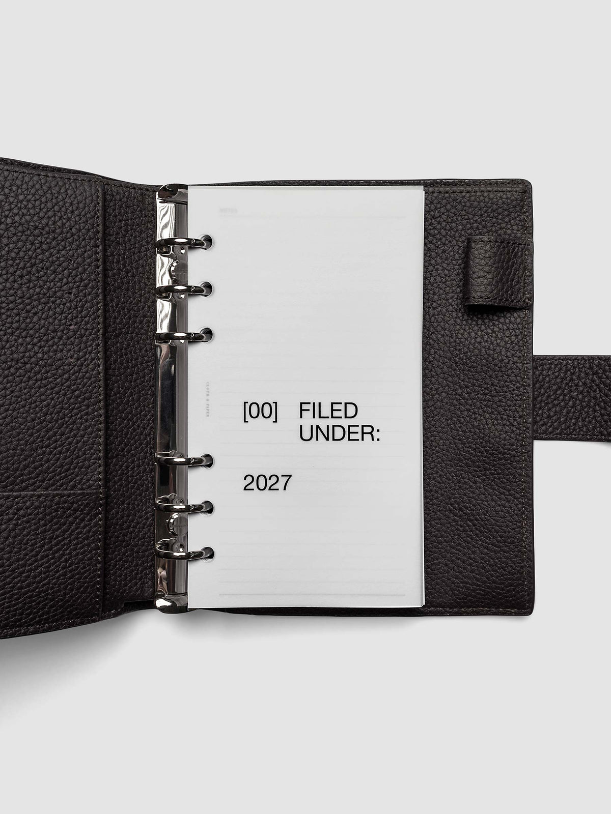 2027 Front + Monthly Dashboard Overlays, Avant Garde, Personal 6-Ring Punch, vellum dashboard overlay shown layered inside a planner