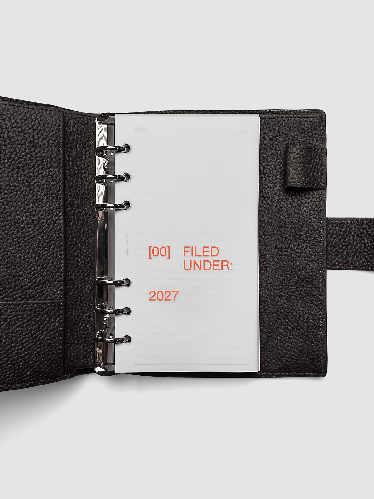 2027 Front + Monthly Dashboard Overlays, Saffron, Personal 6-Ring Punch, vellum dashboard overlay shown layered inside a planner