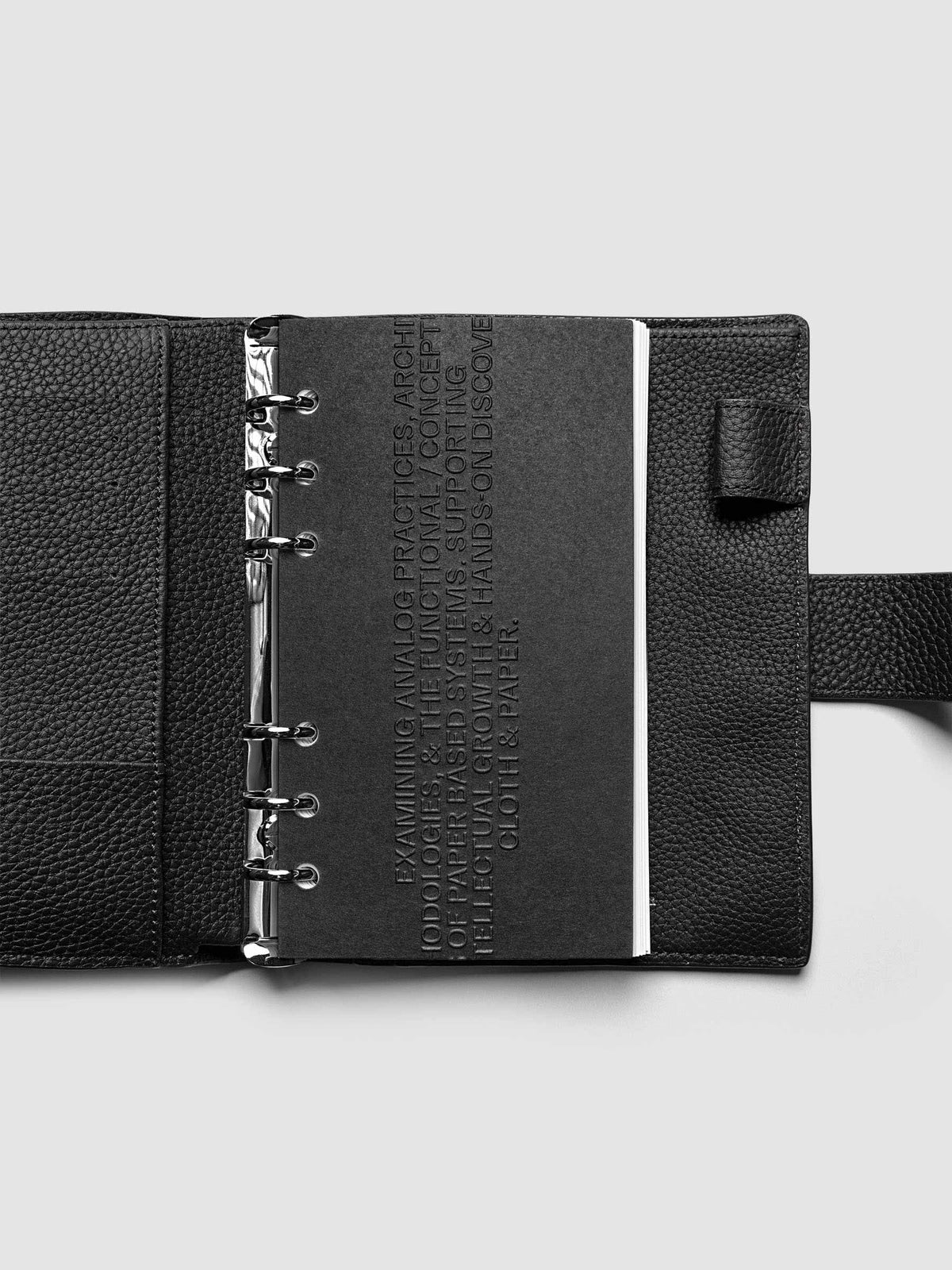 Black embossed Analog Embossed Planner Dashboard without the drop card shown in size Personal.
