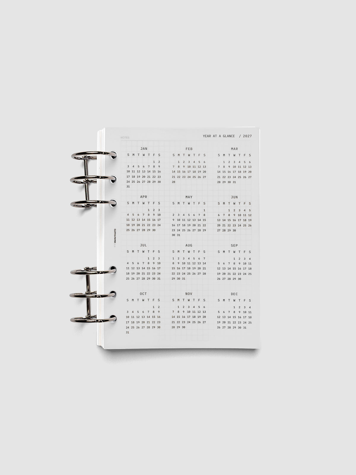 2027 Year At A Glance Dashboard Sunday Start, Personal Wide 6-Ring Punch, translucent vellum year-at-a-glance calendar shown inside a planner