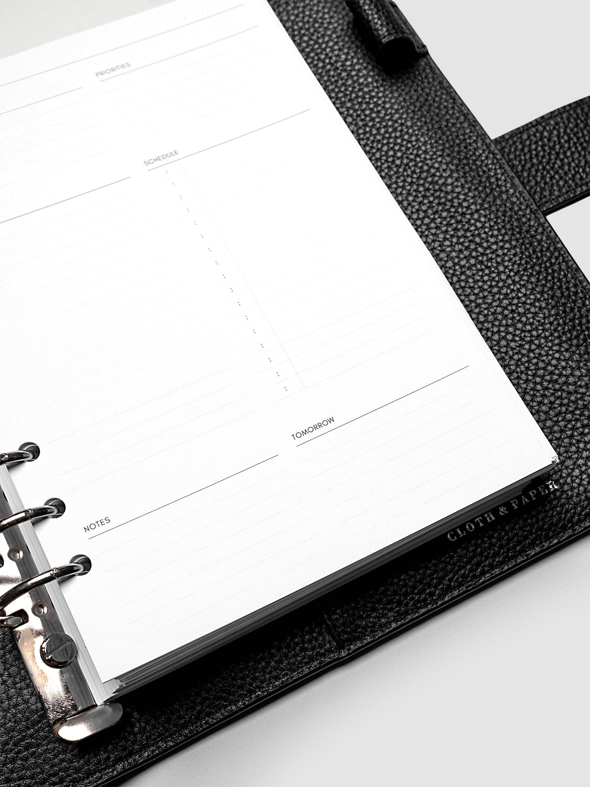 Close up of a blank Daily Essentials Planner insert inside an A5 black agenda.