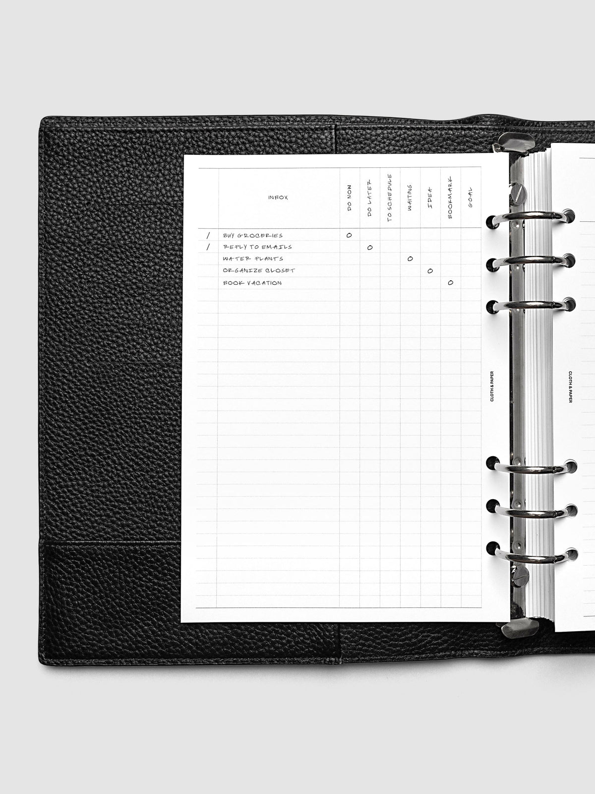 Demo page of the Inbox Sorting Planner Inserts shown pre-punched for 6-Ring A5 planners in a black agenda.