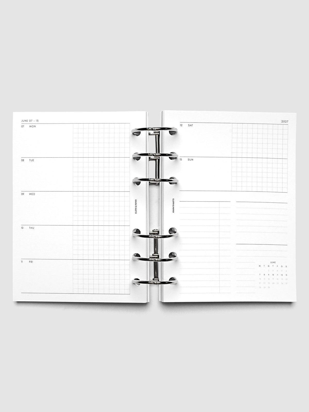 Open planner showing the full two-page 2027 Dated Weekly Horizontal Monday Start spread in A6 6-Ring Punch size, with split open and graph daily columns on the left and weekend dates, tasks, notes, and mini monthly calendar on the right