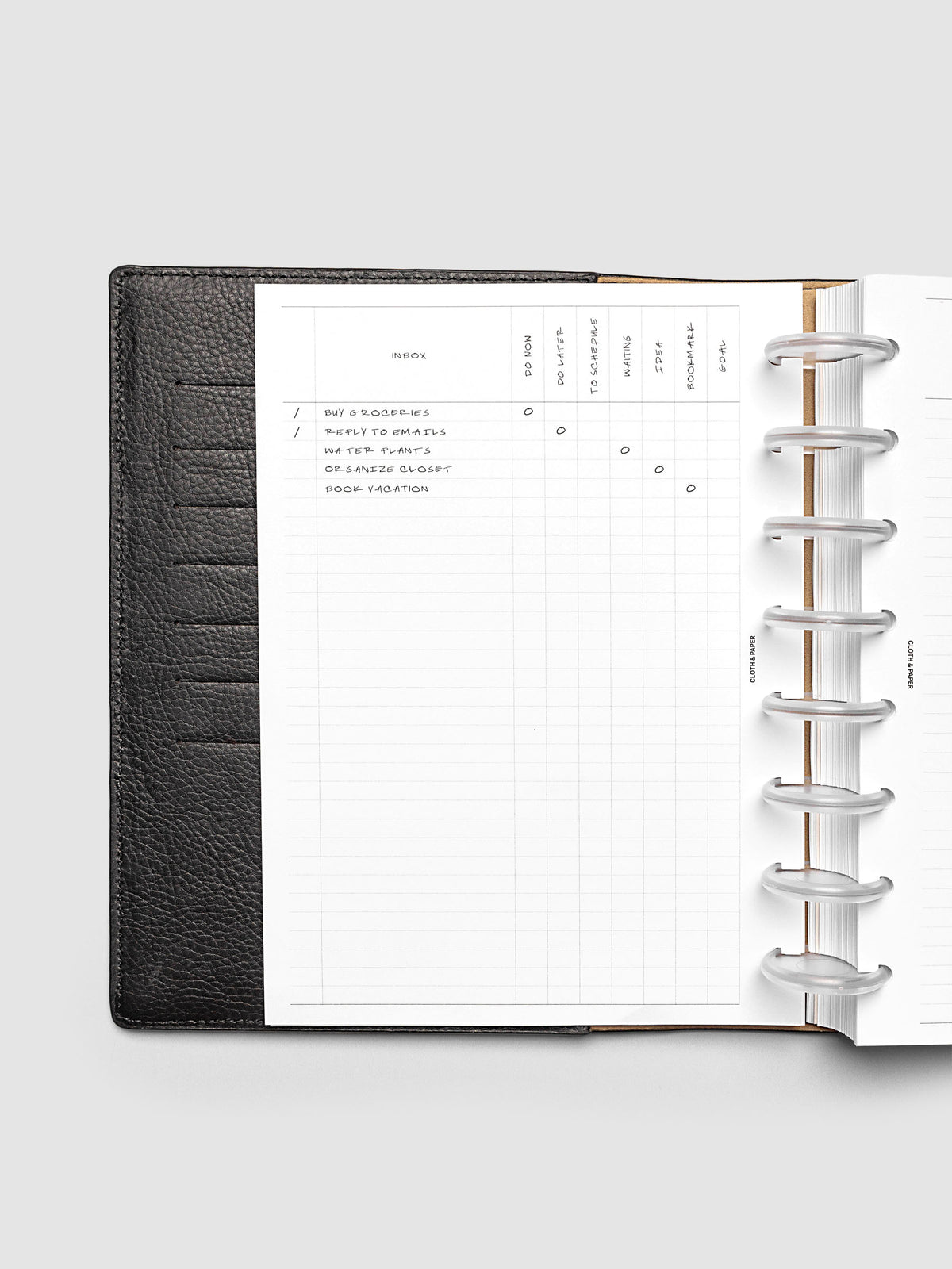 Demo page for Inbox Sorting Planner Inserts shown pre-punched for discbound Half Letter planners in a black folio.