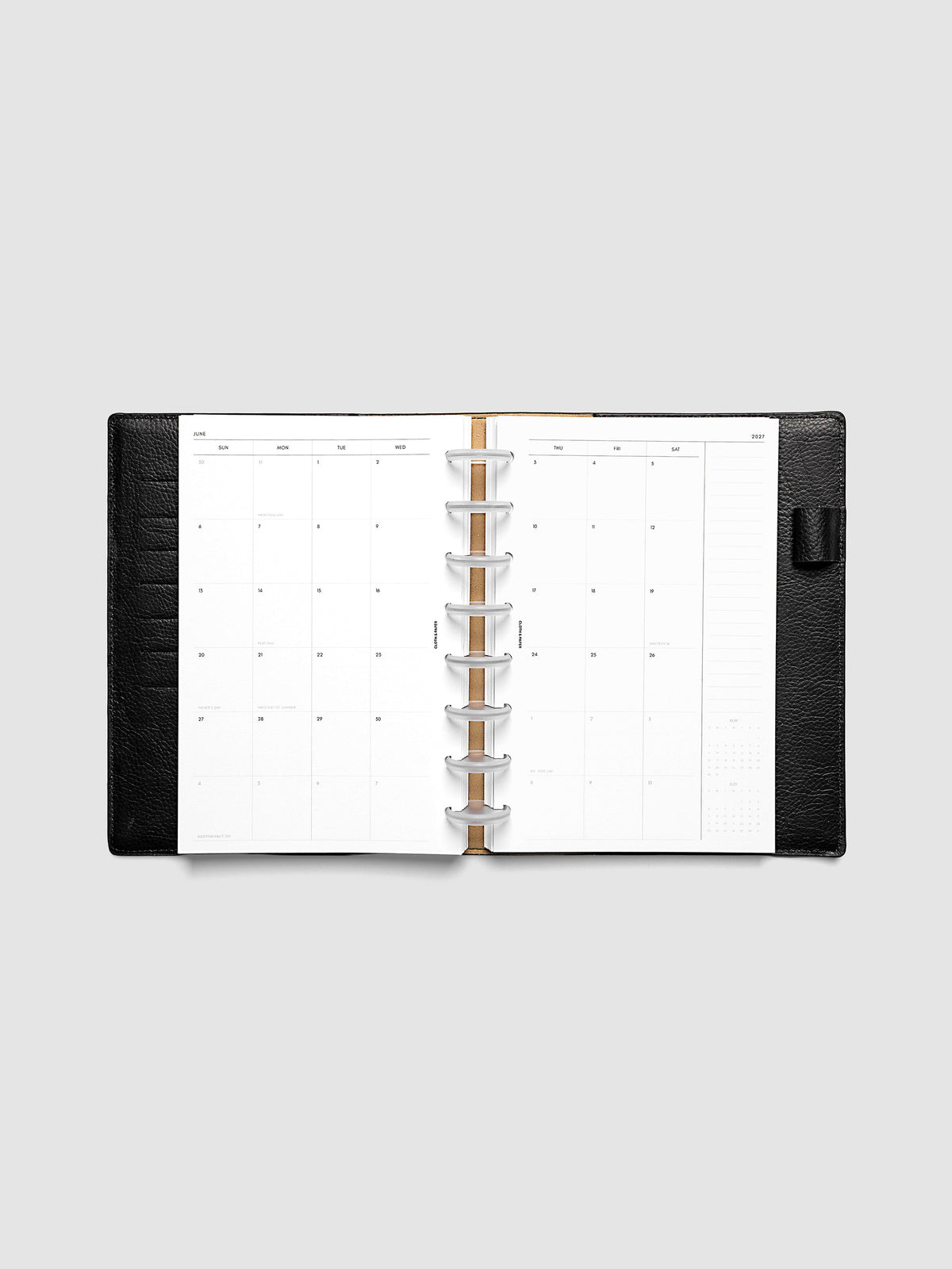 Open planner showing the full two-page 2027 Dated Monthly Sunday Start spread in Half Letter 8-Disc Punch size, with calendar grid, notes column, and mini calendars in the bottom right corner
