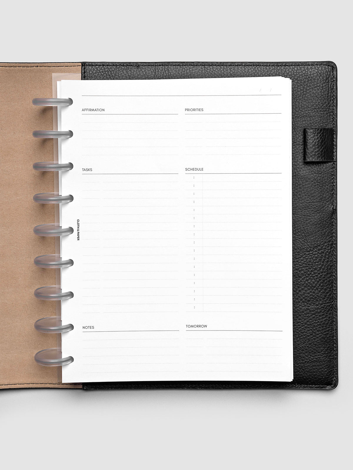 Daily Essentials Planner Inserts shown in size HP Classic inside a black folio.
