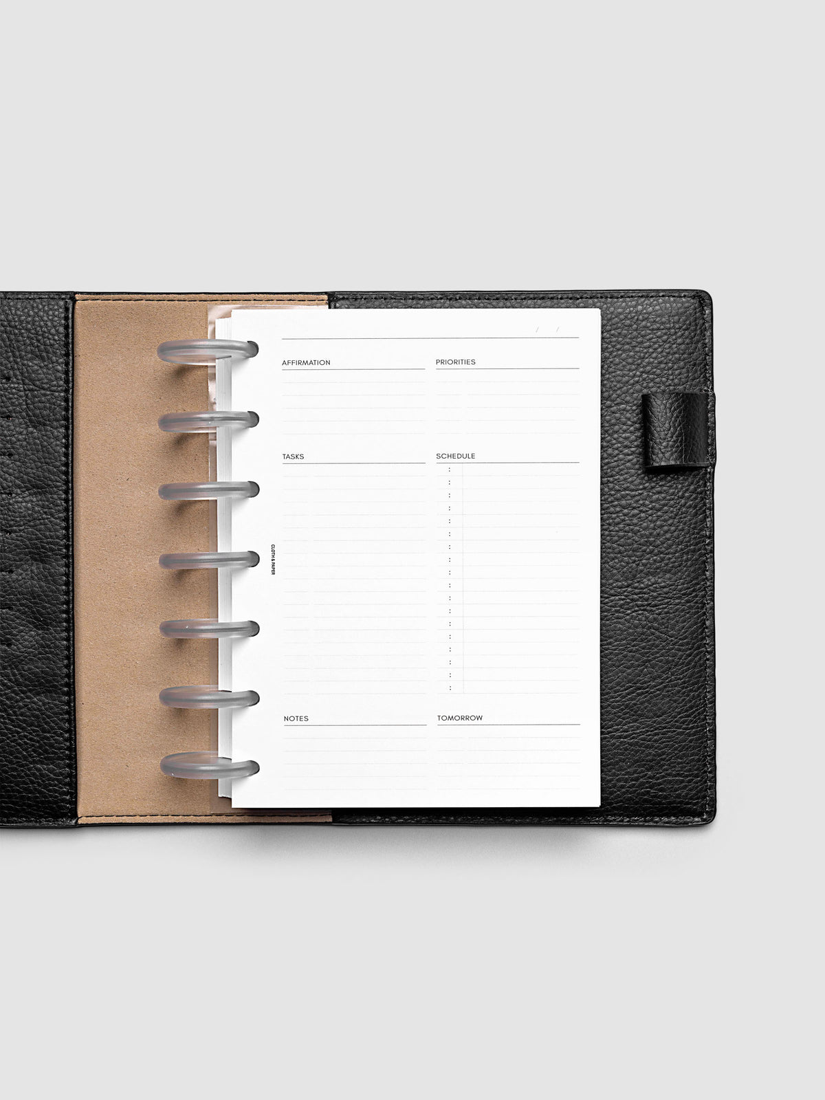Daily Essentials Planner Inserts shown in size HP Mini inside a black folio.