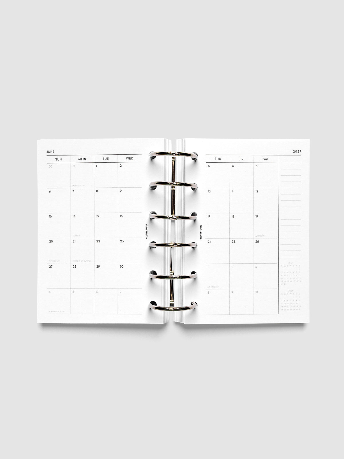 Open planner showing the full two-page 2027 Dated Monthly Sunday Start spread in Pocket 6-Ring Punch size, with calendar grid, notes column, and mini calendars in the bottom right corner