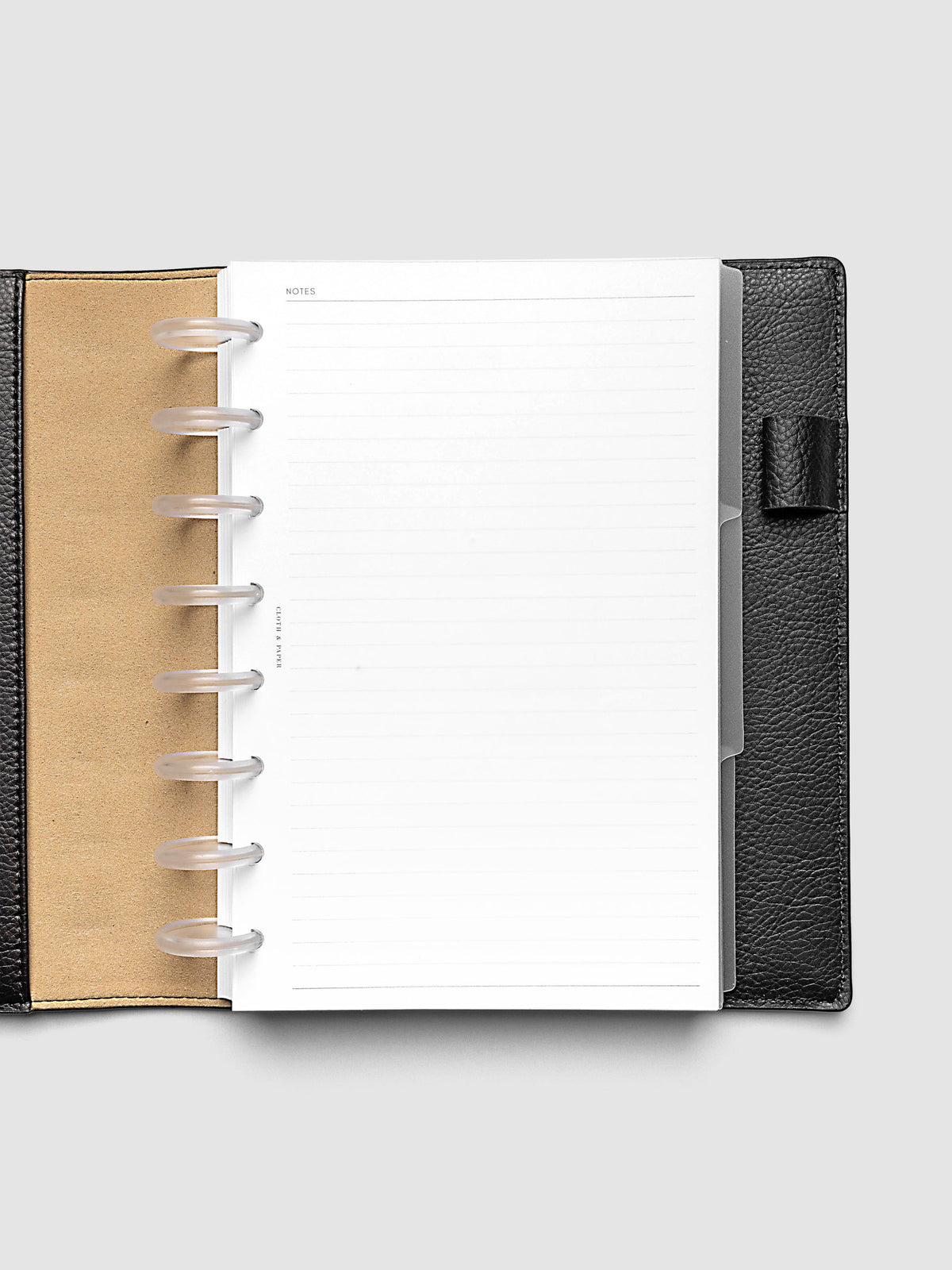 Blank, transparent side tab divider set shown in a Half Letter planner.