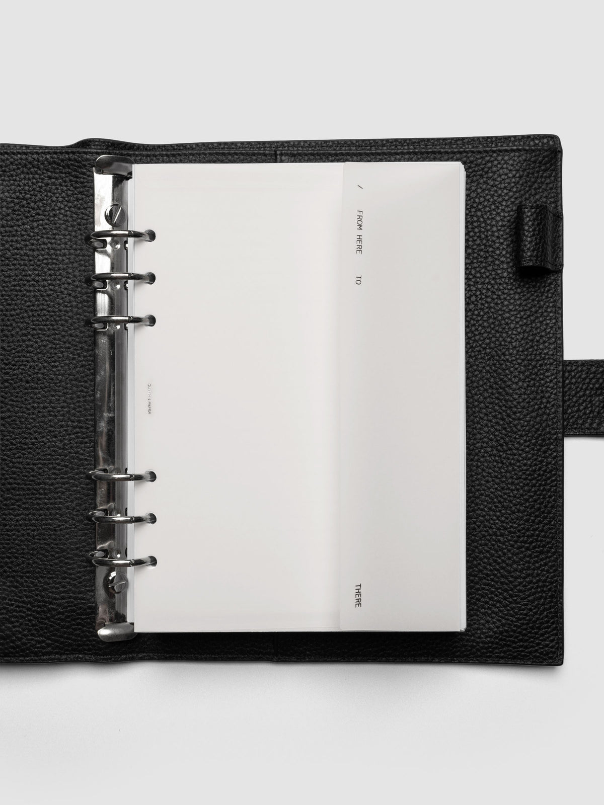 White Envelope Storage Holder shown inside a black, leather A5 agenda.
