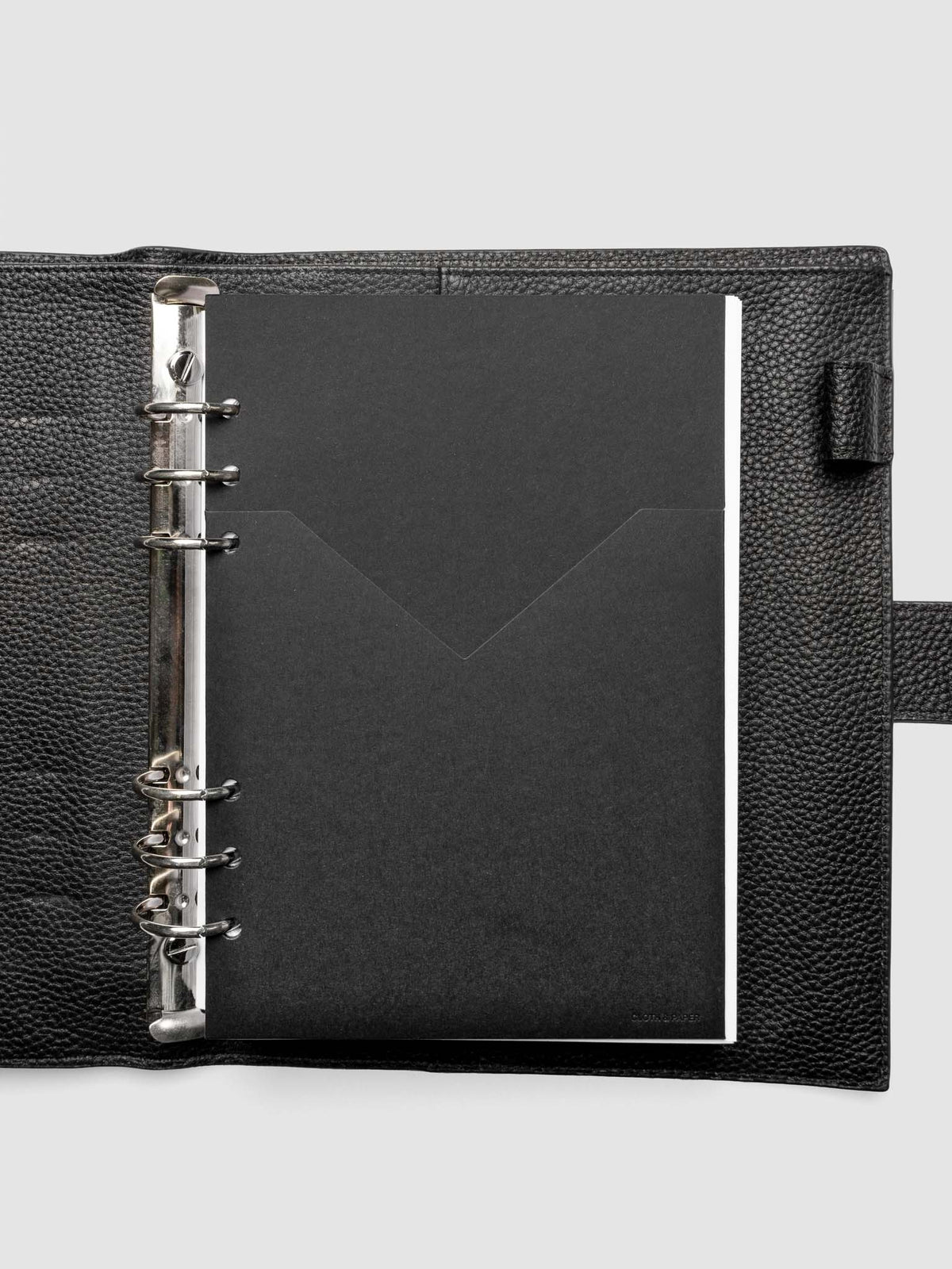 Black planner paper pocket folder shown inside a planner in size A5 6-Ring Punch