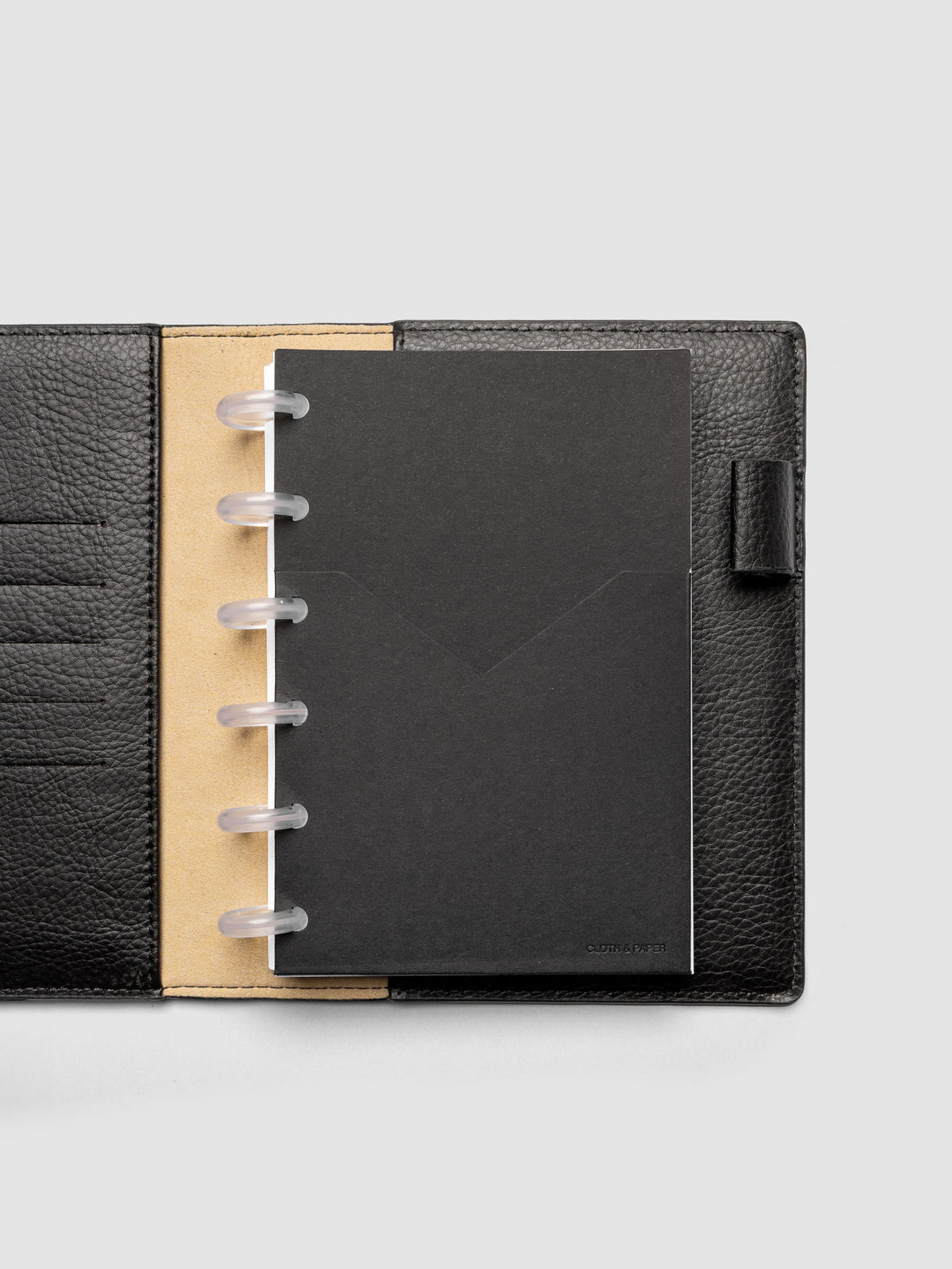 Black planner paper pocket folder shown inside a planner in size CP Petite 6-Disc Punch