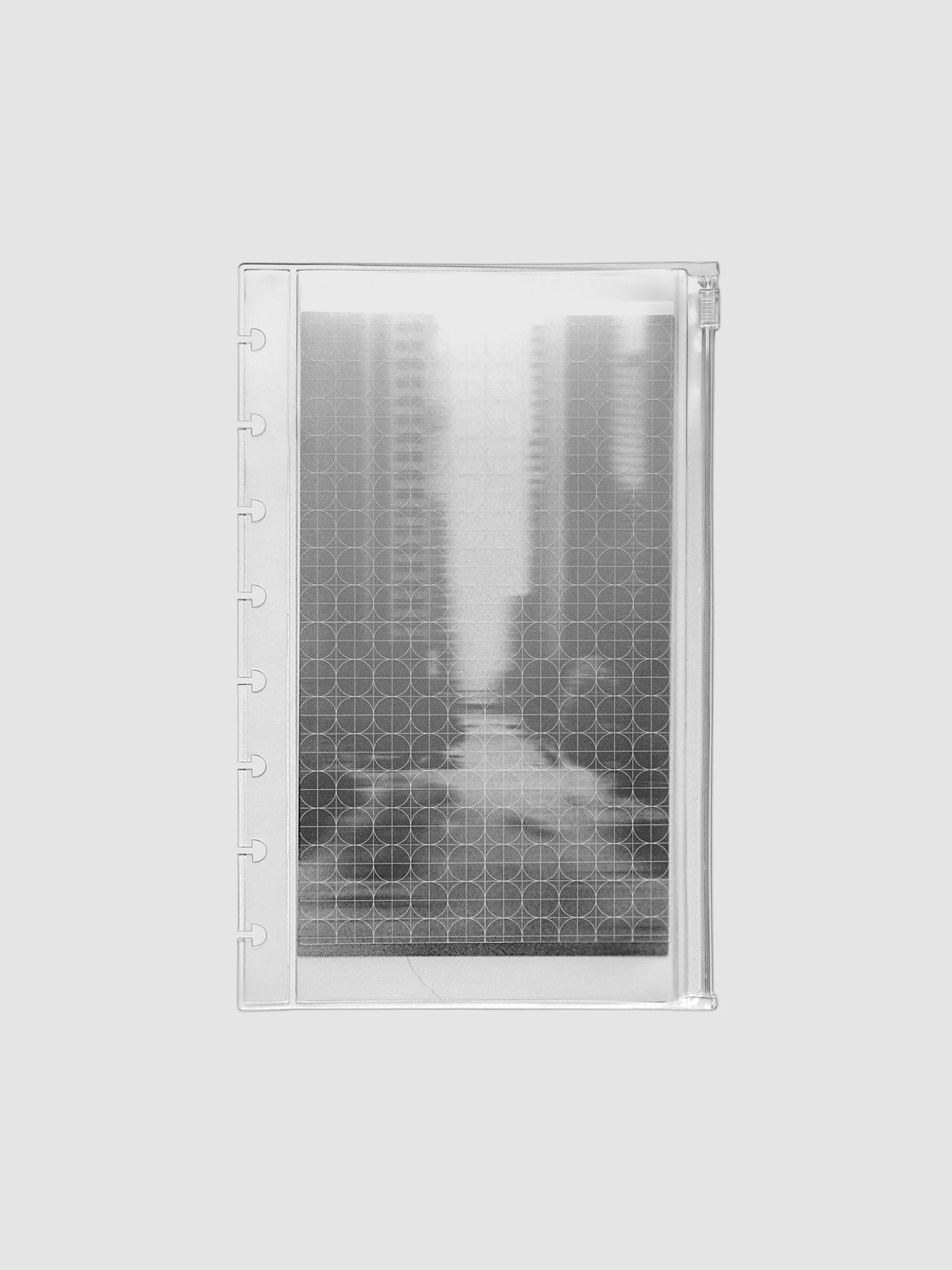 Zippered transparent pouch pre-punched for Half Letter sized discbound planners and notebooks. Features a graph and a photographic decorative inner insert.