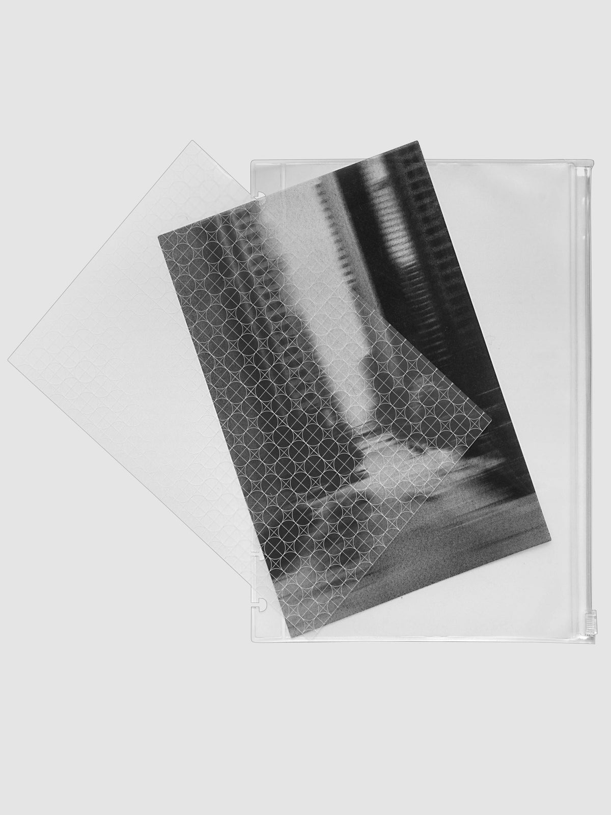 One transparent graph overlay, one black and clear abstract photo overlay, and one clear pre-punched zippered pouch for planners. Shown in size HP Classic.