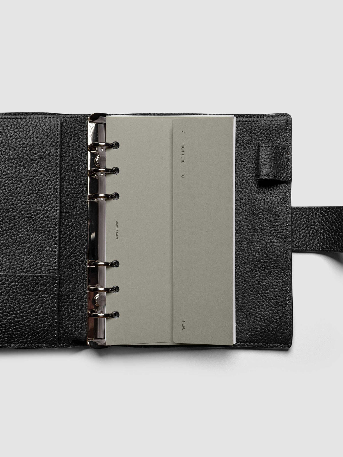 Beige Envelope Storage Holder shown inside a black, leather Pocket agenda.
