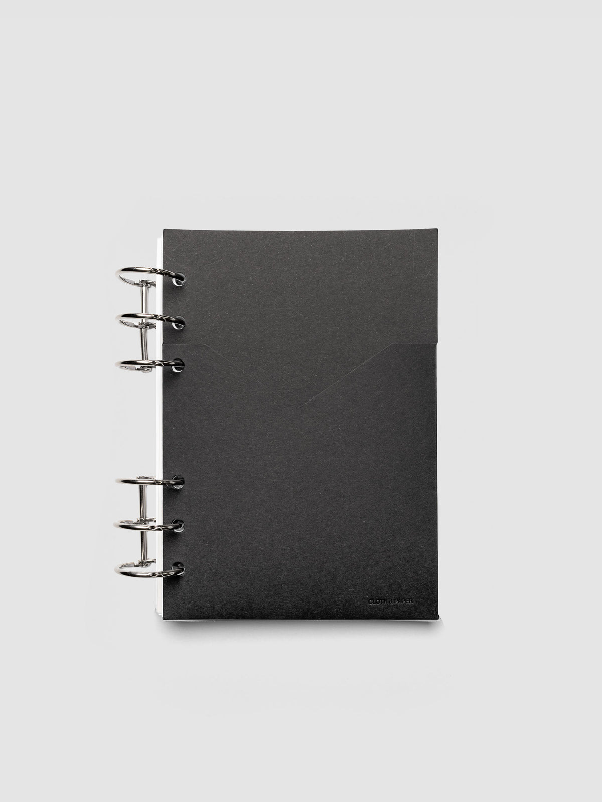 Black planner paper pocket folder shown inside a planner in size Personal Wide 6-Ring Punch