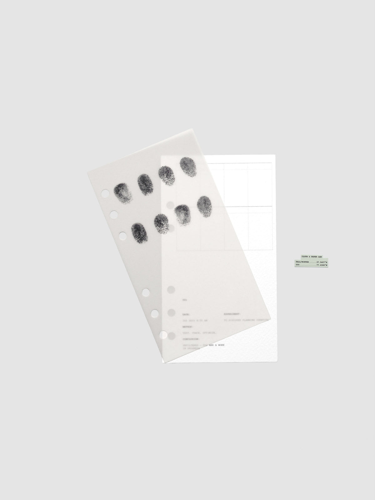 Two layered Personal sized planner dashboards, one semi-transparent, one matte, featuring a fingerprint design shown offset from one another.