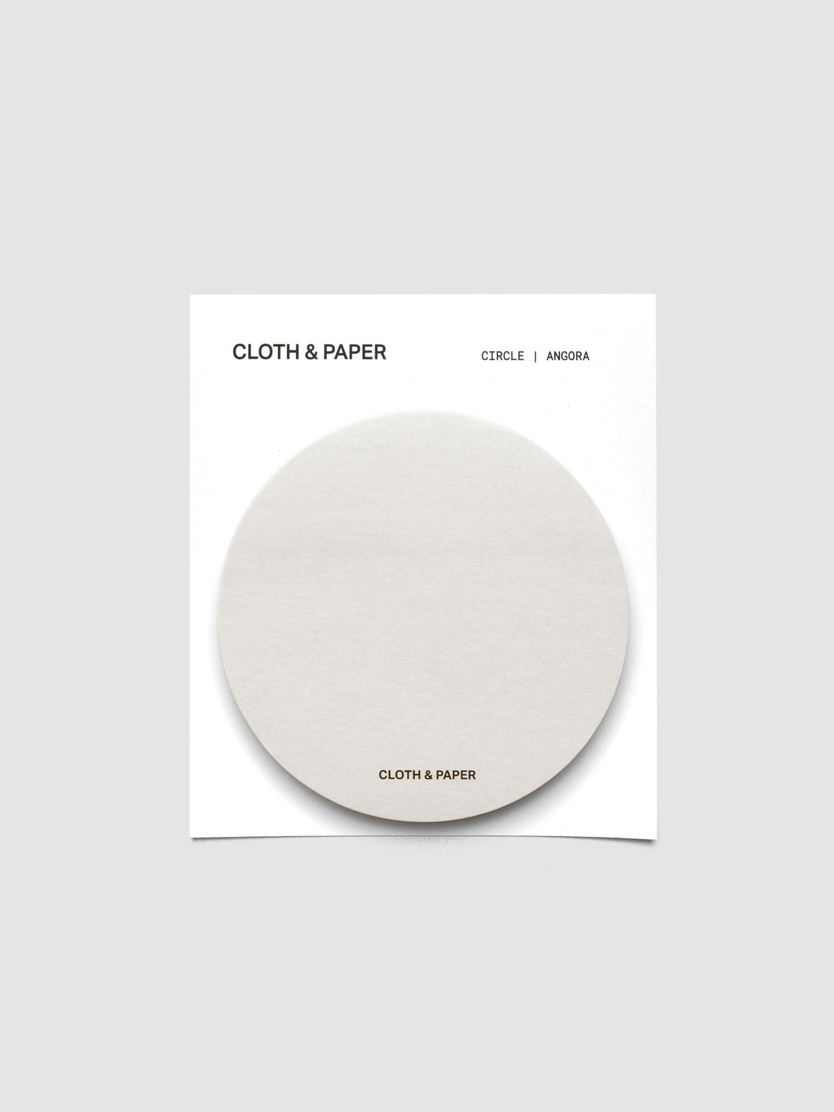 A stack of grey circular sticky notes on a white backer card
