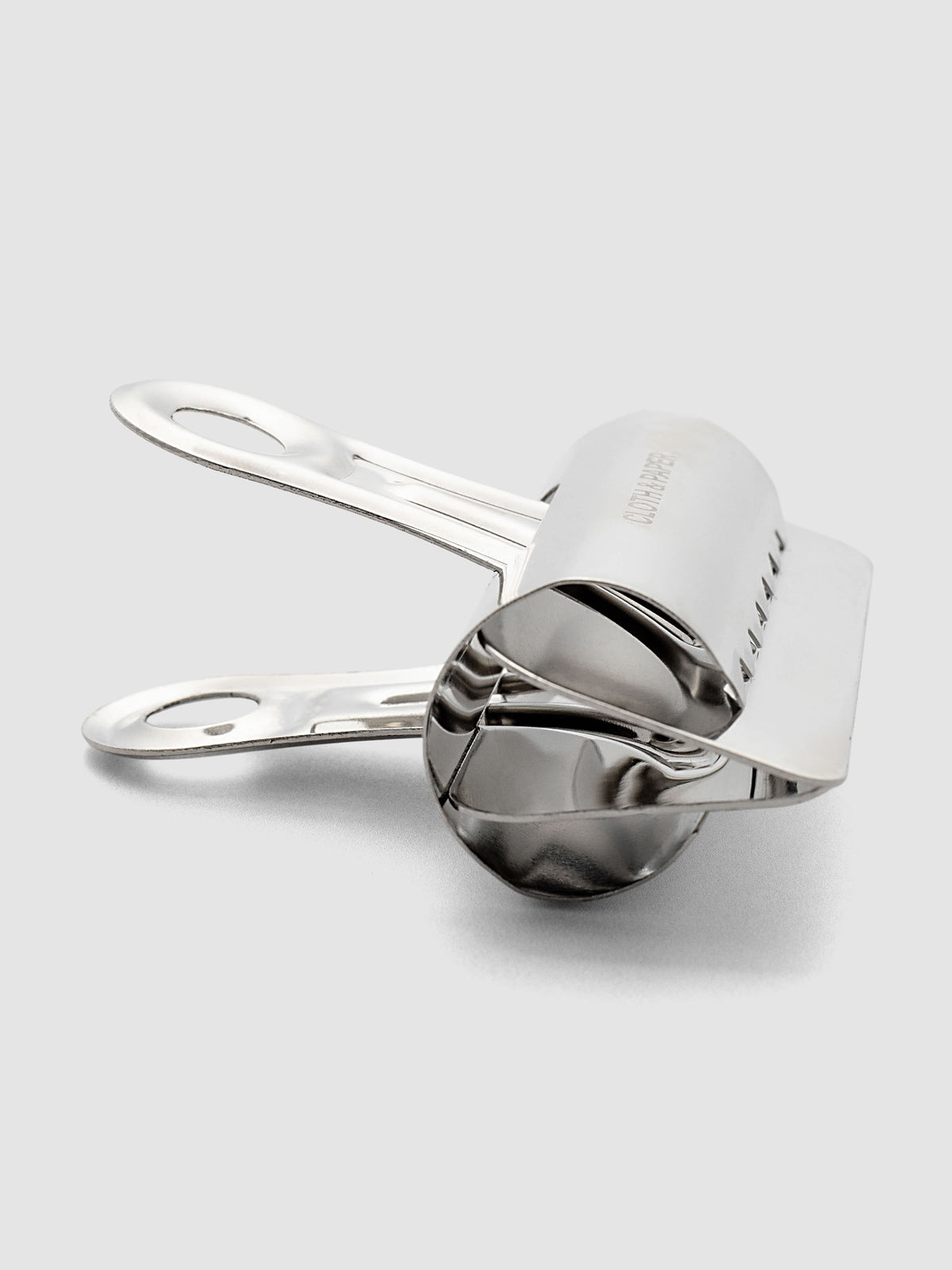 Silver metal notebook clip shown from the side.