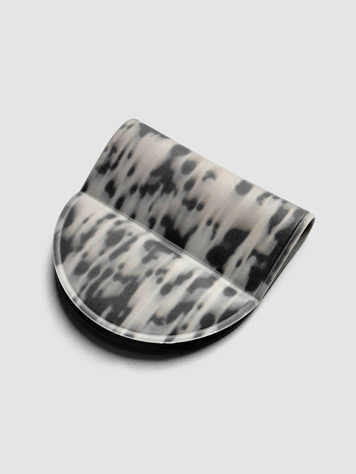Magnetic Bookmark | Pen Holder | Vinyl in Blurred Ink, angled view showing black and off-white speckled pattern