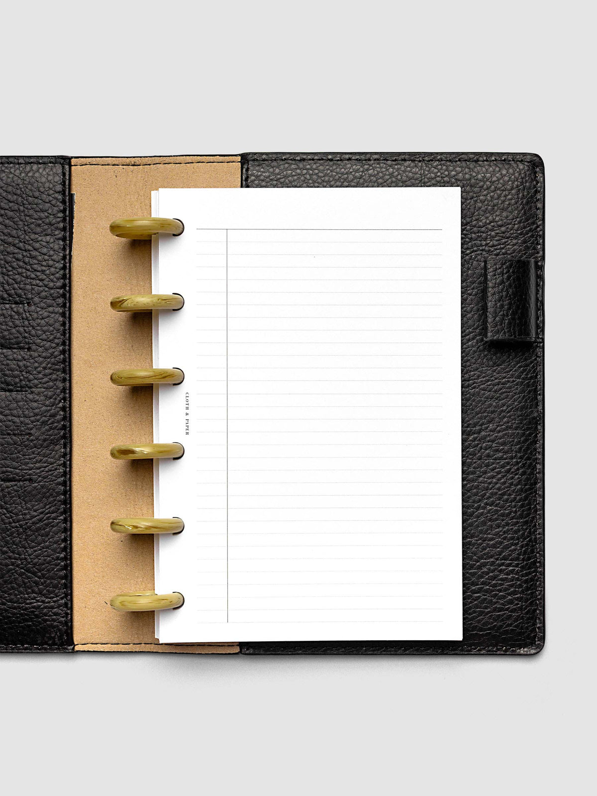 Carrara Verde 1" planner discs in use on an open discbound planner with pages secured on the discs
