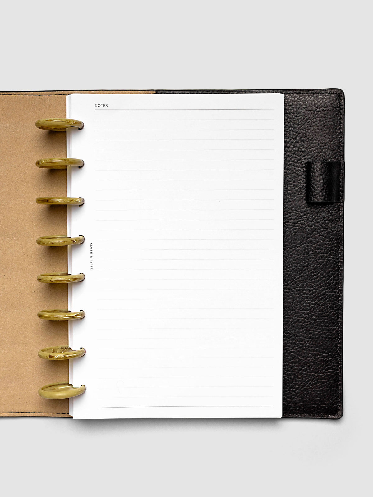 Carrara Verde 1.25" planner discs in use on an open discbound planner with pages secured on the discs