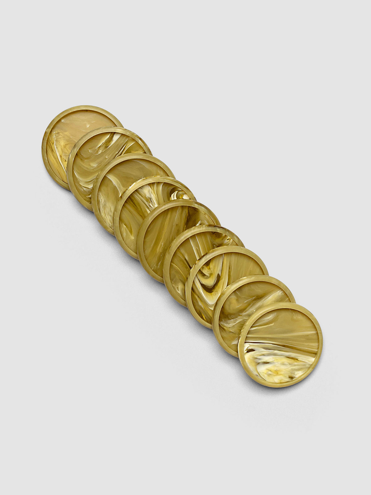 Nine Carrara Verde 1.5" planner discs arranged in a row, showing the bold green marbled printed acrylic finish