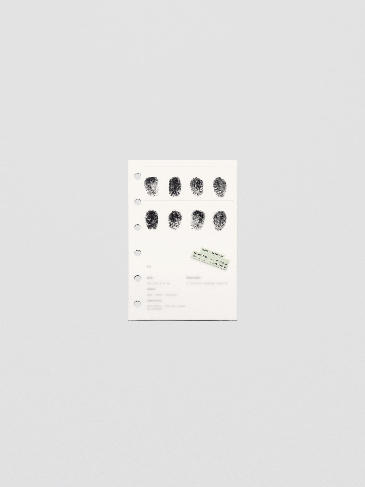 Two layered pocket sized planner dashboards, one semi-transparent, one matte, featuring a fingerprint design.