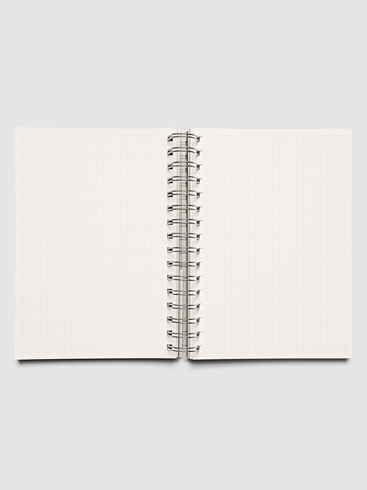 Spiral Notebook in size A5 and color Olive green with graph note interior pages shown open.