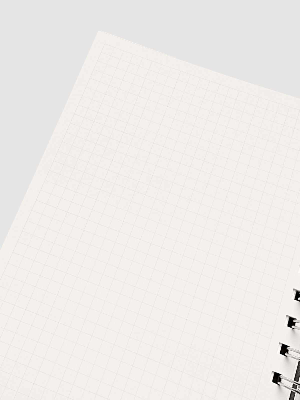 Spiral Notebook in size A5 and color Olive brown with Graph Note interior pages shown open on the left page.