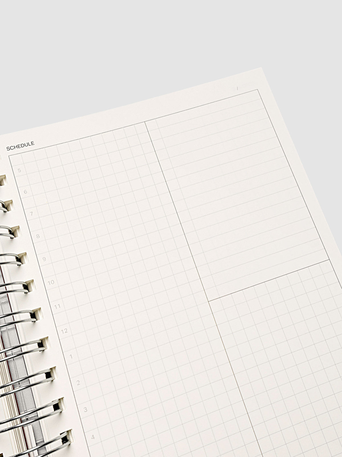 Spiral Notebook in size A5 and color Espresso brown with Daily Time Block interior pages shown open and close up.