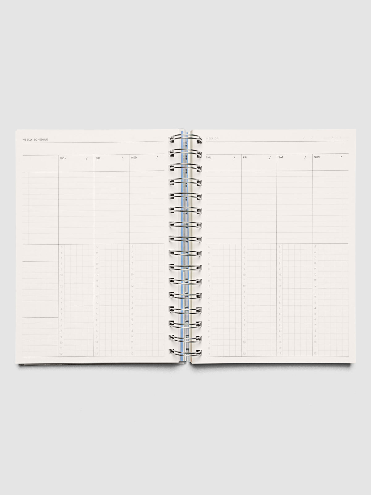 Spiral Notebook in size A5 and color Hyacinth blue with Weekly Time Block interior pages shown open.