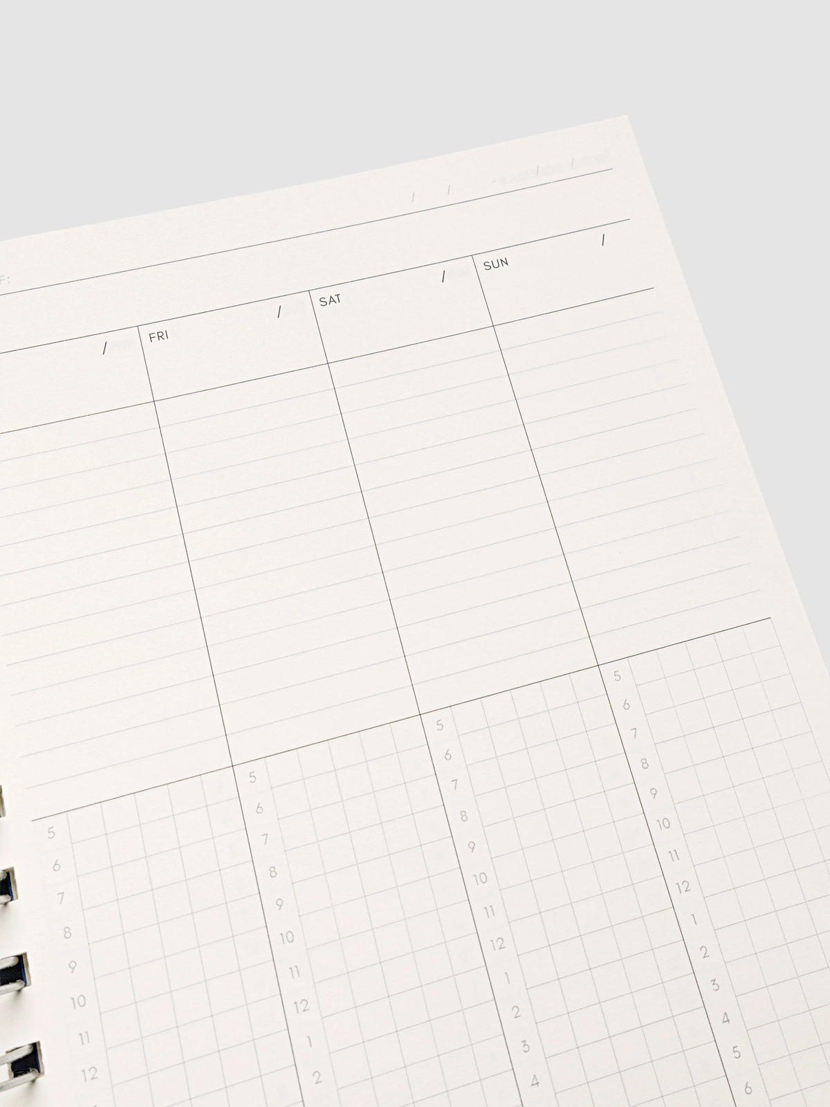 Spiral Notebook in size A5 and color Hyacinth blue shown open and close up displaying vertical weekly time block layout.