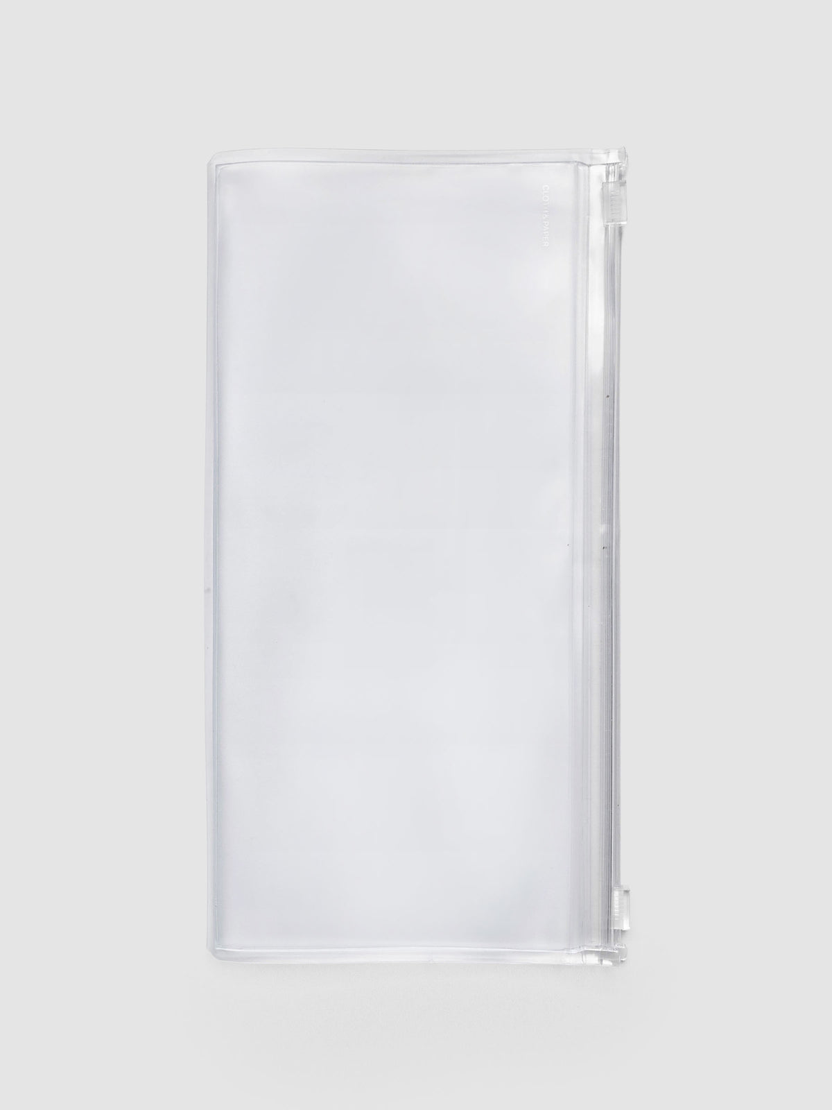 Storage Holder Travel Notebook A5 Slim, empty and closed, frosted clear plastic with silver foil logo, front view