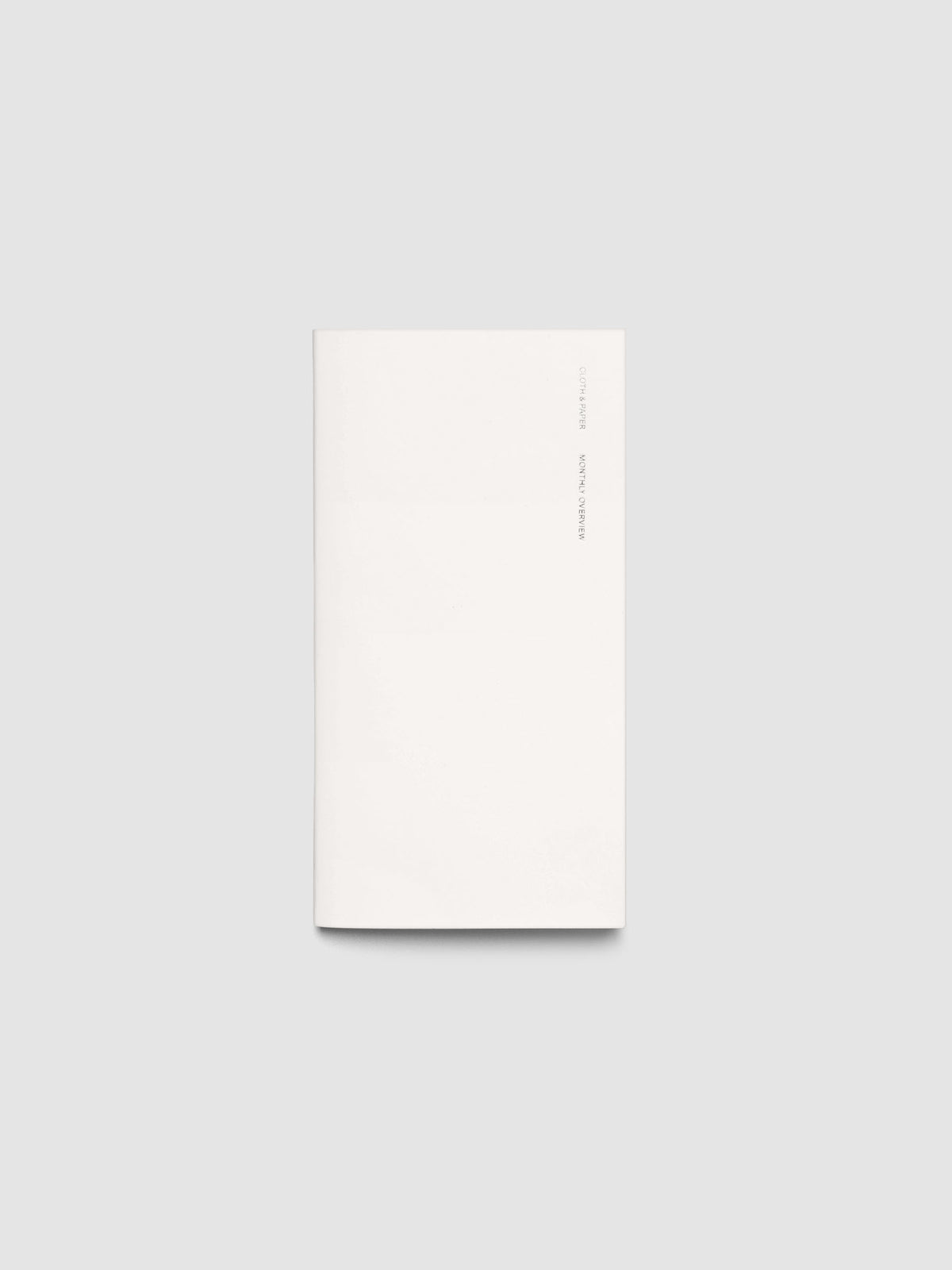 Exterior of a white pocket plus sized travel notebook.