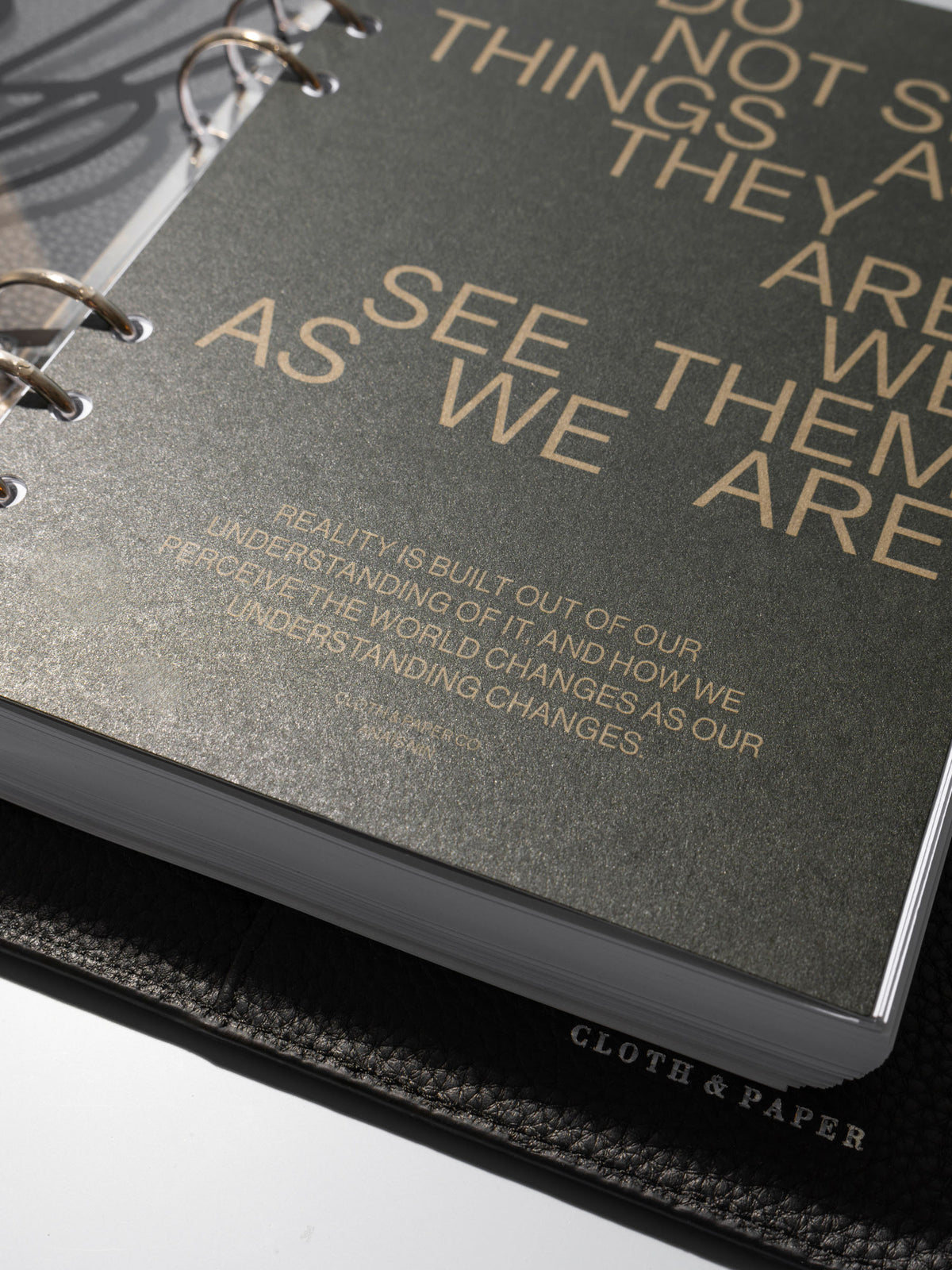 As We Are Cover + Dashboard Set in size A5 shown ring bound in a black leather agenda close up.