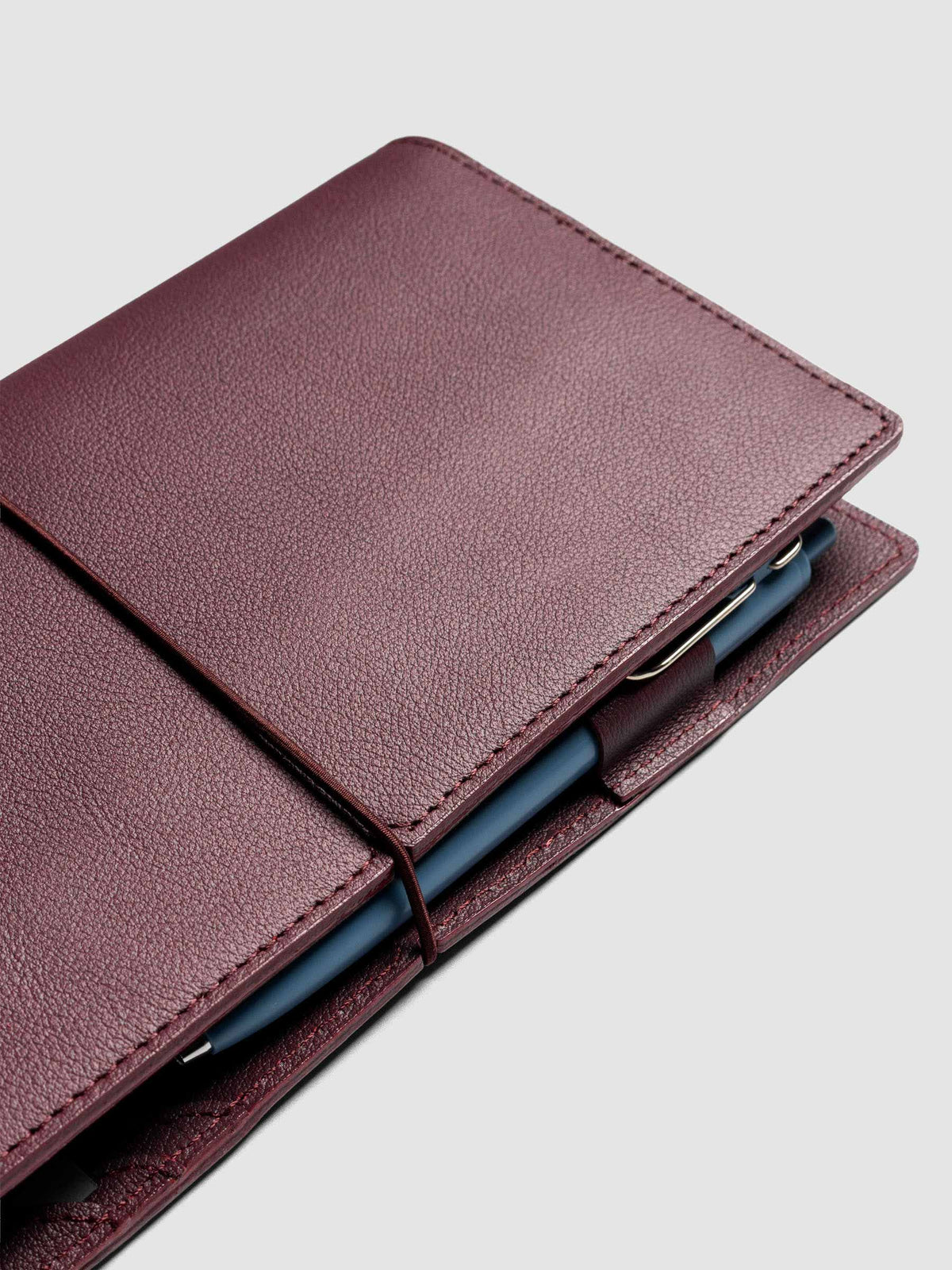 Deep red leather travel notebook cover in size A5 Slim shown closed.