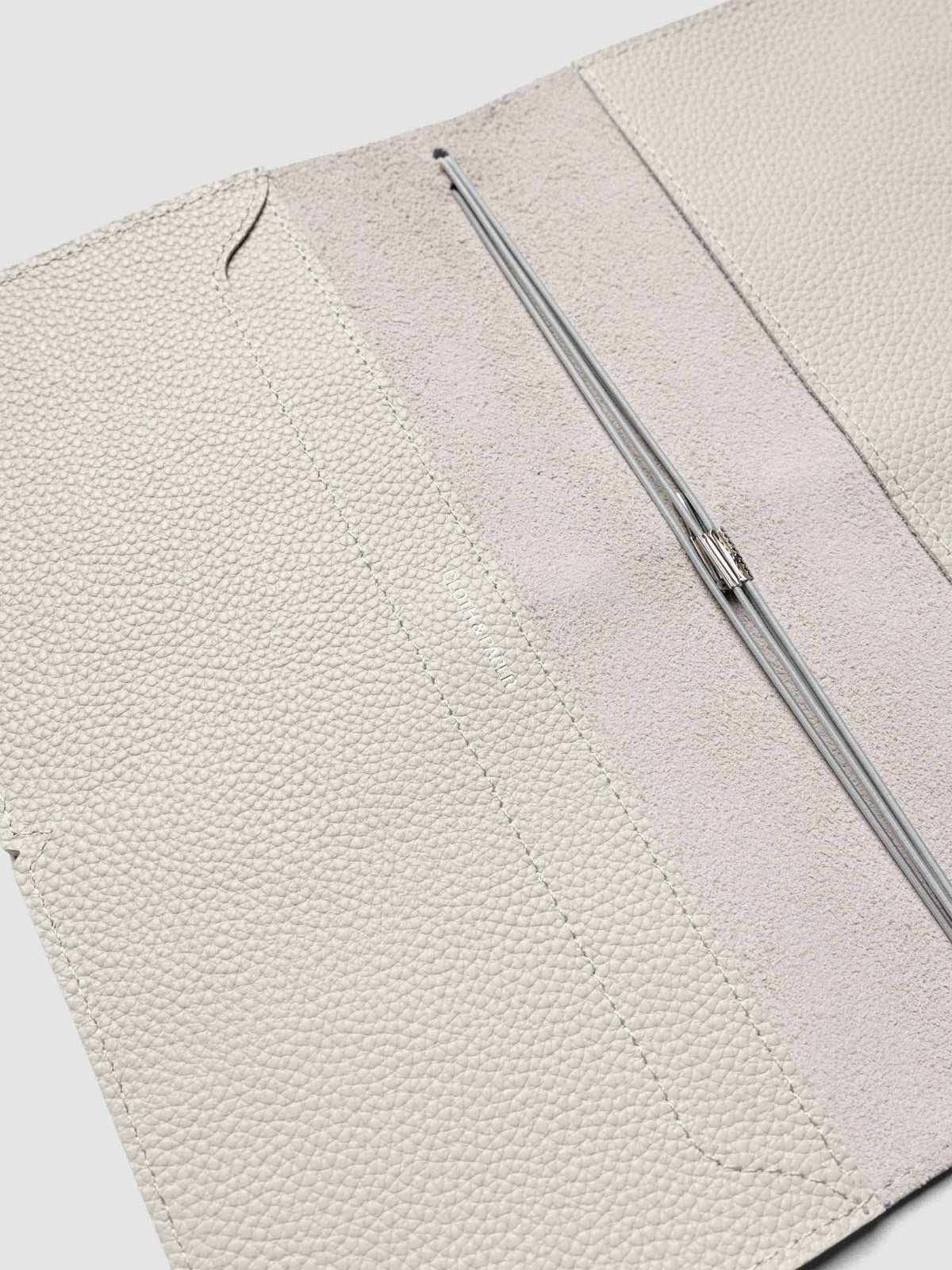Light grey leather travel notebook cover in size A5 Slim shown open with interior pockes and elastic bands.