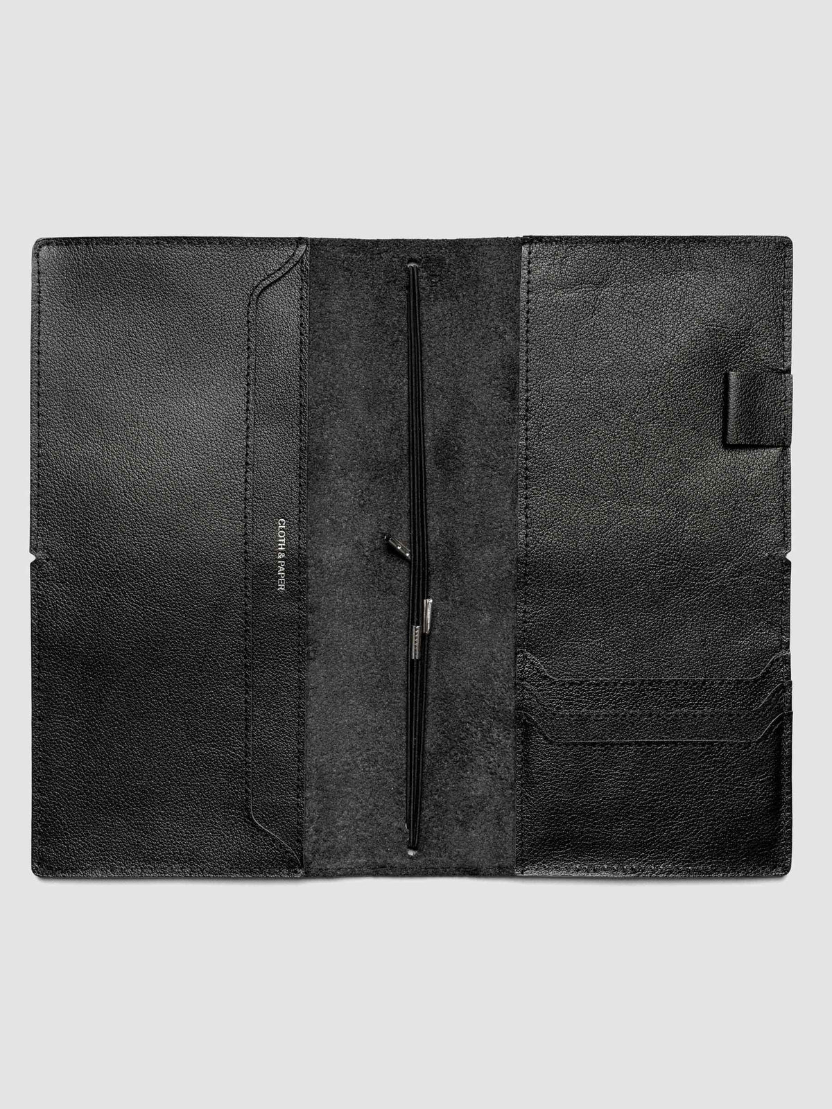 Black leather travel notebook cover in size A5 Slim shown open with interior pockes and elastic bands.
